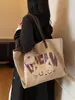 Versión Coreana del Bolso de Lona Ins de Dibujos Animados para Mujer 2025 Nuevo de Gran Capacidad Versátil para Estudiantes, Clases y Viajes al Trabajo Bolso Tote de Hombro