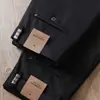 Estación europea otoño e invierno gruesos antiarrugas sin planchar caída alta alta elasticidad para hombre nailon lujo ligero gama alta negocios rectos casuales pantalones