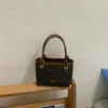 Bolsa de balde de nicho de alta qualidade para mulheres, nova bolsa versátil de outono de 2026, bolsa transversal popular para ir ao trabalho