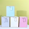 Bolsa de Papel Embossada com Etiqueta Pronta Loja de Roupas Atacado Sacola de Compras Transfronteiriça Cor Única Azul Sacola de Presente