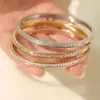 Pulsera de acero de titanio de banda fina con una sola piedra, superventas transfronteriza, chapada en oro de 18 quilates para retención del color, versátil para mujeres, disponible para superponer, directo de fábrica