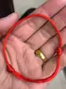 Puesto callejero Feria del Templo Venta caliente Pulsera de Cuerda Roja Jade Imitación Madera Imitación Pulsera Tejida de Cuerda Roja Actividad Mayorista Pequeño Regalo Obsequio