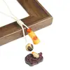 Caballito de palisandro tallado creativo con lingote de oro giratorio incrustado, cadena para teléfono, colgante para mochila, adorno colgante para coche, súper venta