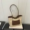 Bolsa tote moderna de alto valor 2026 Outono novo estilo fashion de alta qualidade bloqueio de cores grande capacidade versátil ombro único de mão