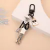 Llavero de Cruz Europeo y Americano Estilo Pareja Personalizado Corazón de Durazno Bolso Cruzado para Hombro Accesorios para Llaves de Mujer Venta al por Mayor