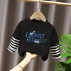 Camiseta de manga larga de algodón puro para niño 2026 primavera y otoño nueva elegante de dibujos animados estilo dos piezas falsas camiseta base de primavera para niño
