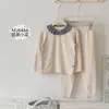 Conjunto de Pijama Infantil con Estampado Completo de Conejo Panadero Otoño 2026, Nuevo Top y Pantalones de Lana Elástica de Cuello Redondo para el Hogar Otoño-Invierno