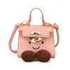 Bolso de mano transfronterizo para mujer, nueva colección otoño/invierno, diseño de cara sonriente linda, mini bolso Kelly, elegante, adecuado para niñas, a juego para padres e hijos, y divertido bolso cruzado de pintalabios