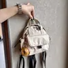 Mochila pequeña ligera y linda, versión de cuero impermeable, bolso de mano pequeño, mochila de moda impermeable versátil
