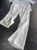 Estilo moderno de calle, corte diagonal y diseño patchwork, pantalones casuales ligeramente acampanados para hombre, nueva colección primavera/otoño, corte ajustado, pantalones largos de pierna recta