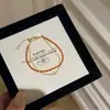 Pulsera apilada de cuerda roja tejida Benmingnian Diseño avanzado Nicho Versátil Pulsera de doble capa de cuerda roja Pulsera para mujer