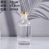 Botellas Redondas de Vidrio para Aromaterapia al por Mayor en Stock, Botellas de Relleno de Difusor de Aroma sin Llama de Gama Alta, Botellas Vacías de 200 ml para Montar en el Coche