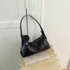 Bolso de mano minimalista de nicho estilo coreano para mujer, nuevo de moda principios de otoño 2026, de alto valor, bandolera casual de color sólido