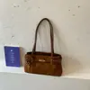 Bolso de hombro de nicho transfronterizo con diseño de hebilla de cinturón, nuevo modelo 2026, textura de lino, bolso baguette para el día a día