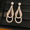 Aretes de plata con zirconia y diseño de gota de agua, elegantes y versátiles, aretes de lujo de alta gama al por mayor