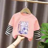 Camiseta de manga larga para niña, nuevo modelo primavera y otoño 2026, body falso de dos piezas para bebé, ropa infantil de algodón puro con rayas de dibujos animados