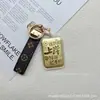 Llavero de Oro Puro 999 Colgante Bolsa de Aterrizaje Dorada Accesorio de Moda Versátil Venta al por Mayor desde la Tienda Water Shell