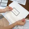 Bolsa de embalaje para ropa de papel de algodón blanco ecológico, bolsa autosellante para ropa, bolsa de embalaje impermeable, bolsa de embalaje semi-transparente esmerilada de alta gama