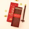 Palillos para ganar dinero Qinglan en stock 5 pares de palillos caja caja de regalo caja de embalaje palillos de titanio palillos de madera de ala de pollo caja de papel caja vacía