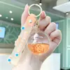 Chaveiro Estrela Preenchido com Óleo e Areia Movediça Desenho Animado, Chaveiro de Boneca Transparente em Acrílico com Areia Movediça, Decoração para Mochila de Estudante