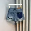 Ins da moda cintura alta cor contrastante desfiado Shorts jeans femininos 2023 Verão novo lavados soltos linha A perna larga com babados hot pants