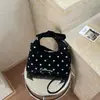 Bolso de mano retro de lunares de nicho para mujer, estilo principios de otoño 2026, elegante y versátil, simple bolso de hombro y bandolera con lazo