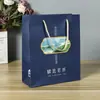 En stock al por mayor bolsa de regalo portátil bolsa para empaque de regalo de boda bolsa de papel avanzada para tienda de ropa