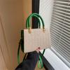 Bolso tejido de paja para mujer, primavera 2023, nuevo bolso de mano informal de moda, bolso de hombro tejido de gran capacidad de color sólido.