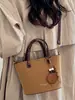 Bolso tipo cubo estilo retro para mujer, nueva colección otoño 2026, diseño coreano simple y casual, alta calidad, bolso de hombro de color liso