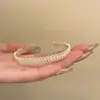 Anillo de circón hueco de lujo ligero, diseño de nicho, anillo abierto de alta gama, nuevo accesorio de moda popular 2026