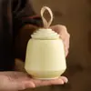 Fabricante Reloj Redondo Apilable Lata de Té Pequeña Portátil Cerámica Uso Doméstico Sensación de Alta Gama Lata de Té Lata Sellada 2026 Nuevo Estilo
