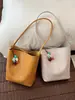 Bolsa Saco de Cor Sólida com Padrão Trançado para Mulheres Moda Verão 2026 Nova Bolsa de Mão Casual para Trabalho e Deslocamento Bolsa de Ombro