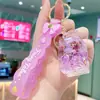 Nuevo Llavero Anillo de Botella con Muñeca de Arena Líquida, Colgante Exquisito de Dibujos Animados para Mochila para Niñas y Niños, Accesorio de Pareja, Pequeño Regalo para Eventos