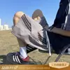 Shorts de verano de moda para hombre 2026 con un toque de alta gama, diseño creativo de tres rayas, pantalones casuales de playa holgados de longitud media