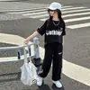 Comercio Exterior 2026 Verano Nuevo Estilo Conjunto de Ropa Deportiva Casual de Moda Versátil para Niñas de Manga Corta y Pantalón Largo en Stock