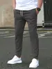 Otoño 2026 Nuevos Pantalones Casuales de Corte Delgado con Etiqueta de Cuero de Nueve Puntos Color Sólido Pantalones Casuales con Bolsillos