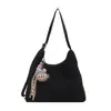 Bolsa Feminina Listrada em Cores Contrastantes 2025 Nova Bolsa de Ombro com Pingente para o Dia a Dia Estilo Coreano Lona Casual Bolsa de Ombro Transversal