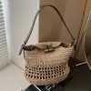Bolso Tejido de Verano Transfronterizo para Mujer 2026 Nuevo Estilo Calado de un Solo Hombro Estilo Pastoral Estilo Perezoso Cubo de Paja Bolso Cruzado