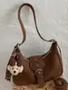 Bolsa de Ombro Shuai Mi Jia para Uso Diário Feminino, Nova Coleção Outono 2026 Estilo Motociclista Vintage, Bolsa de Mão Moderna e Estilosa