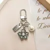 Nuevo de Moda Venta Caliente Transfronteriza Estilo Coreano Flor de Cinco Pétalos Niña Flor de Pera Colgante Llavero Accesorio Decoración para Bolsa Zouju