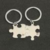 Pequeno presente atacado transfronteiriço exclusivo metal casal pingente criativo mochila ornamentos de aço inoxidável quebra-cabeça chaveiro