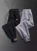 Pantalones casuales al por mayor para hombre otoño e invierno forrados de polar engrosados pantalones deportivos para hombre pantalones de punta suelta una generación de pelo