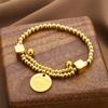Estilo de lujo ligero transfronterizo europeo y americano pulsera simple de disco con letra de acero de titanio femenina de alta gama de lujo moderna personalidad pulsera de salto disco