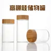 Tapa de Madera de Bambú Manchada Frasco de Vidrio Sellado Botella para Miel Botella de Vidrio Botella para Medicamentos Fabricante Venta al por Mayor Botella de Vidrio Transparente con Tapa