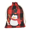 Bolsa de algodón con cordón de Navidad al por mayor bolsa de almacenamiento de dulces y regalos Bolsa de algodón con diseño de pingüino a cuadros navideños personalización