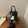 Mini bolso cubeta de lunares estilo coreano para mujer, nuevo modelo 2026, bolso de mano dulce y femenino, bolso cruzado para teléfono versátil de nicho