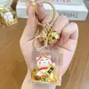 Gato da Sorte Ano Novo Estatueta Trazedor de Riqueza Garrafa com Areia Movediça Chaveiro de Carro Pingente Acessório Fofo para Mochila Presente Venda por Atacado
