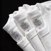 Camiseta blanca de algodón puro de Xinjiang, peso pesado, cuello redondo, manga corta para hombre y mujer, top casual holgado de manga corta para verano, color liso
