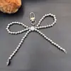 Nuevo Colgante de Lazo de Amor Plateado para Funda de Teléfono Móvil Llavero Colgante Versátil Exquisito Regalo Pequeño Accesorios para Equipaje
