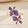 Pulsera de brazo retorcido con flor de goteo de aceite estilo metálico europeo y americano, pulsera única y dulce, joyería transfronteriza de nicho de alta gama